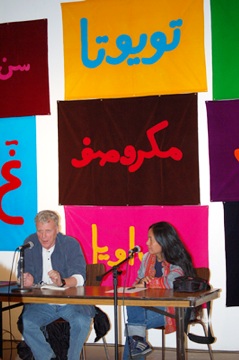 Ray Lagenbach and Arahmaiani in conversation at Artspace, Sydney, 2007 in front of flags from Arahmaiani's work Make up or Break up