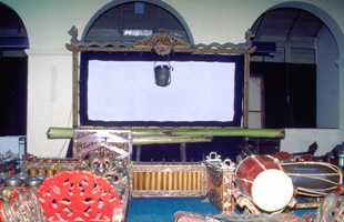 Wayang Museum, Kota, Jakarta. Screen with the traditional lamp and banana tree trunk and Gamelan orchestra in the foreground. The sticks of the Wayang figures are stabbed into the trunk and held until required by the Dalang.